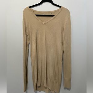 Long sleeved, long tan sweater.